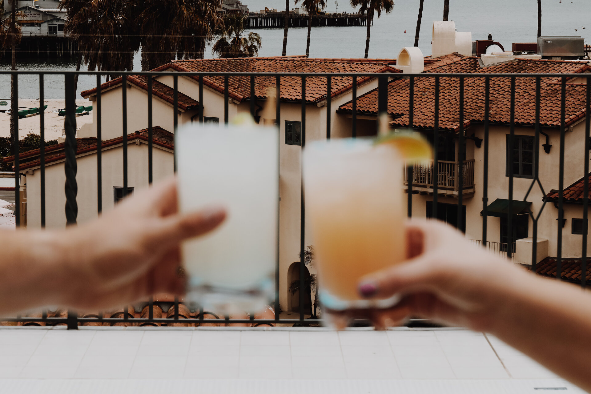 people holding cocktails on pool deck